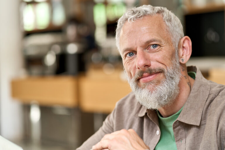 Happy middle aged old gray-haired bearded man close up headshot portrait